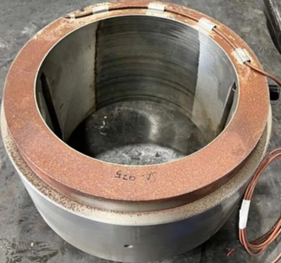 Turbine journal bearing before repair, showing worn and scored white metal surfaces